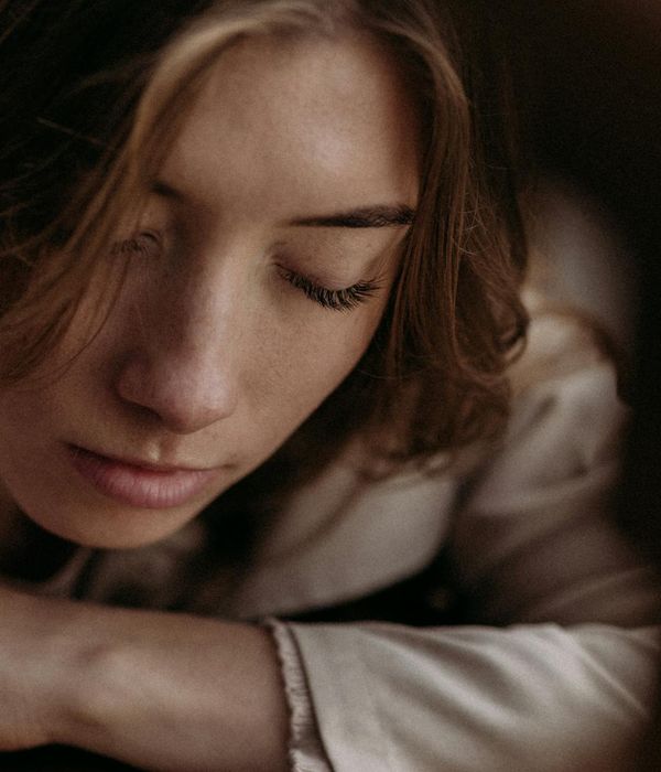 Woman with closed eyes in a state of calm relaxation.